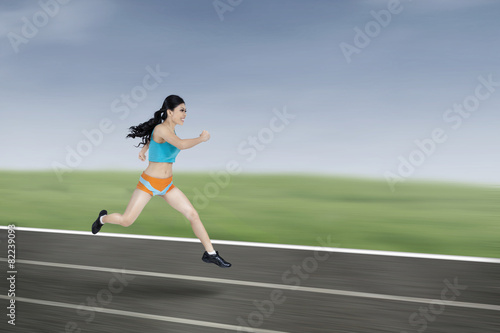 Young athletic woman running © Creativa Images