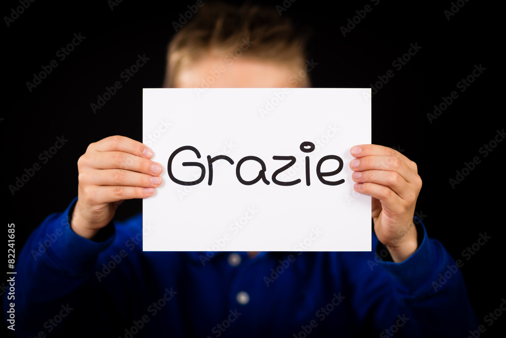 Child holding sign with Italian word Grazie - Thank You Child holding sign with Italian word Grazie - Thank You