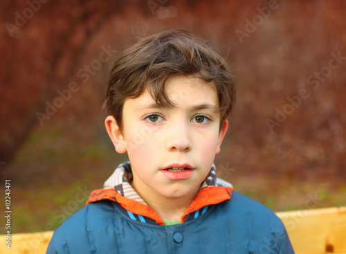 preteen handsome boy close up portrait in the spring park photo