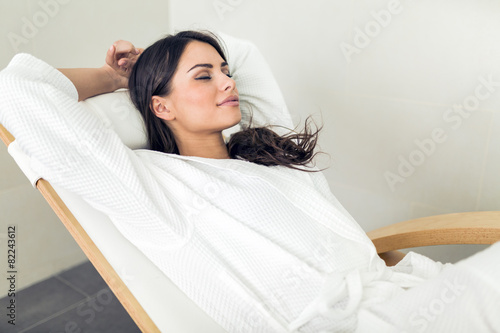 Portrait of a beautiful young woman relaxing in a robe