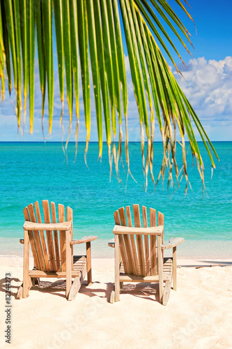 two beach chairs on tropical shore