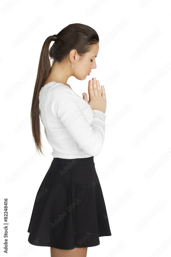 Brunette woman standing for white background with her hands fold Brunette woman standing for white background with her hands fold