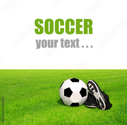soccer ball and shoes in grass on white background