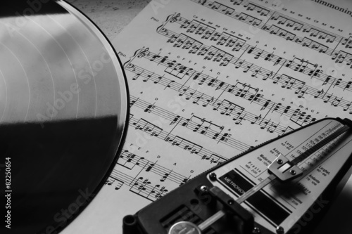 Metronome and vinyl on sheet music