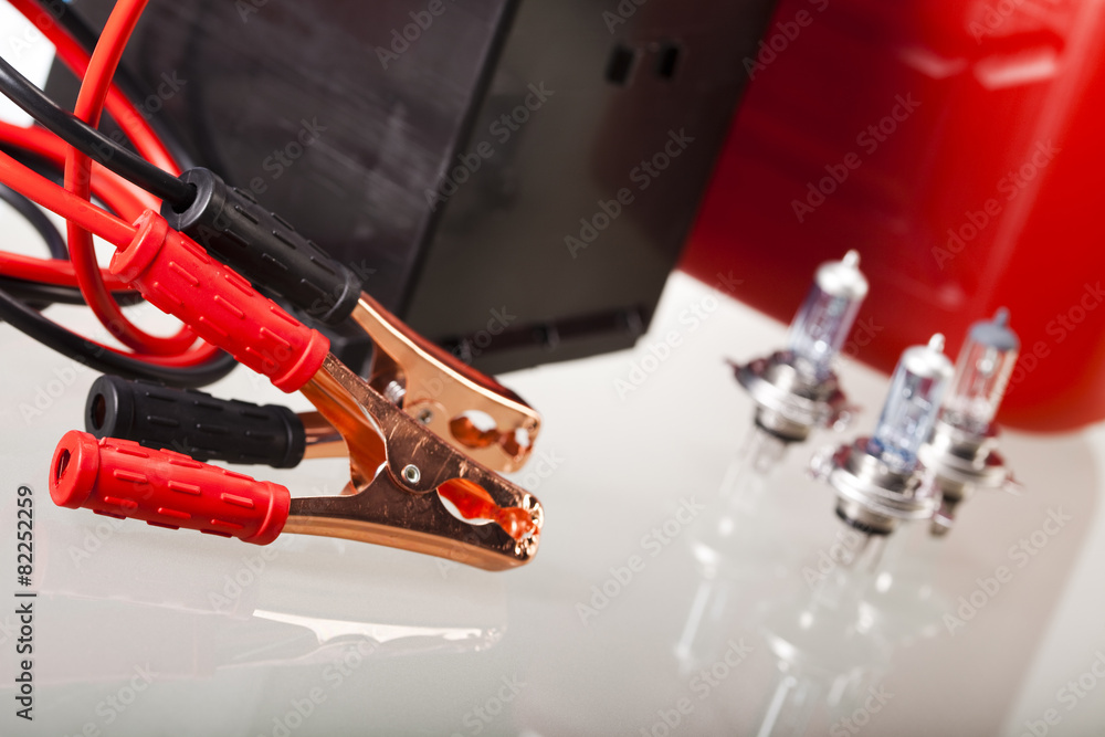 Car battery with two jumper cables clipped on vivid moto concept Car battery with two jumper cables clipped on vivid moto concept