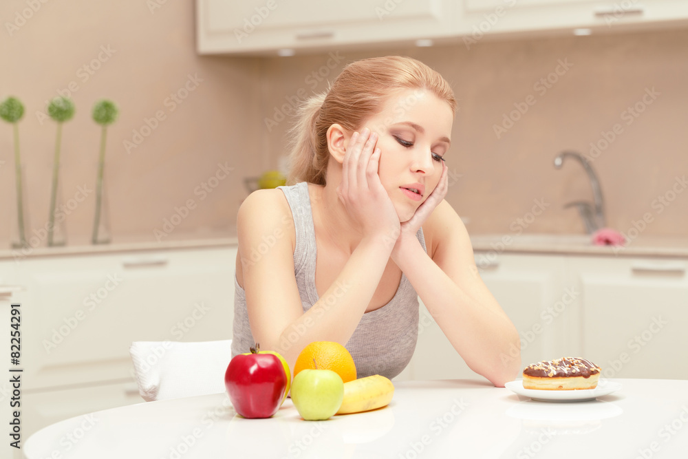 Woman looks at donut and wants to eat it Woman looks at donut and wants to eat it