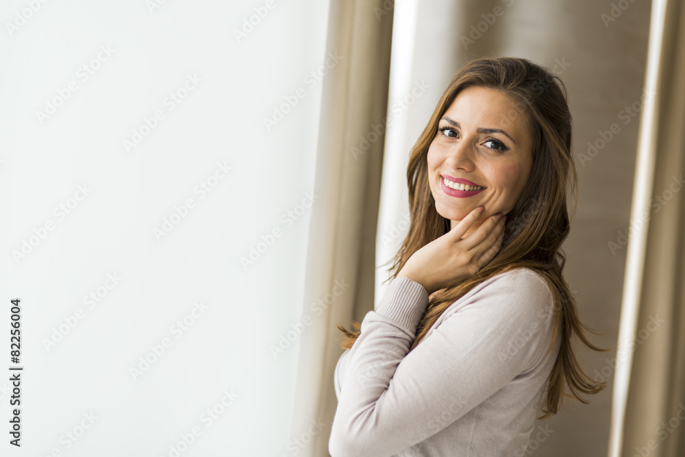 Beautiful and successful brunette posing in front of a window Beautiful and successful brunette posing in front of a window