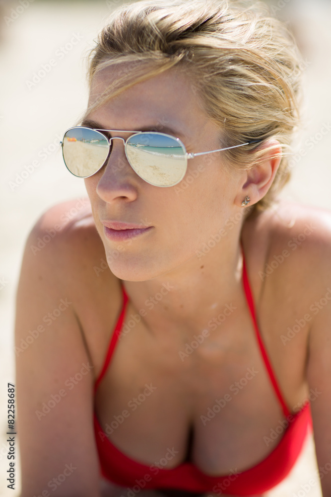 Beautiful blonde woman in red swimsuit and sun glasses Beautiful blonde woman in red swimsuit and sun glasses