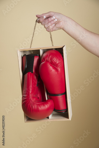 Pair of red boxing gloves in a wooden box © petert2