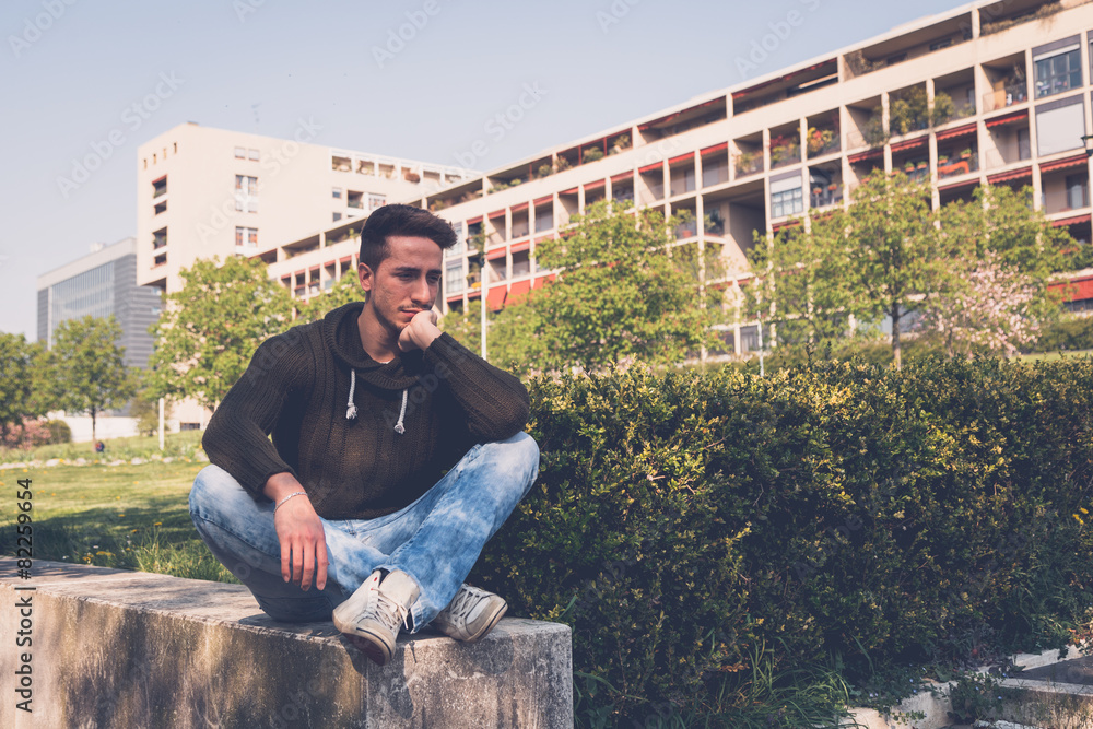 Young man posing in an urban context Young man posing in an urban context