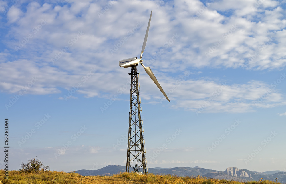 Mast with wind power generator on the background of sky. Mast with wind power generator on the background of sky.