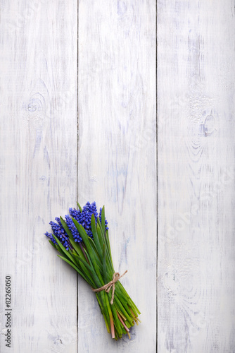 spring flowers bouquet on wooden table. Top view, copy space.
