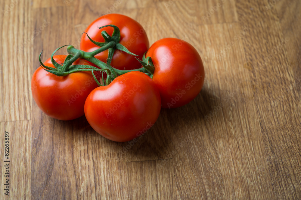 Fresh and tasty tomatoes on a wooden table Fresh and tasty tomatoes on a wooden table