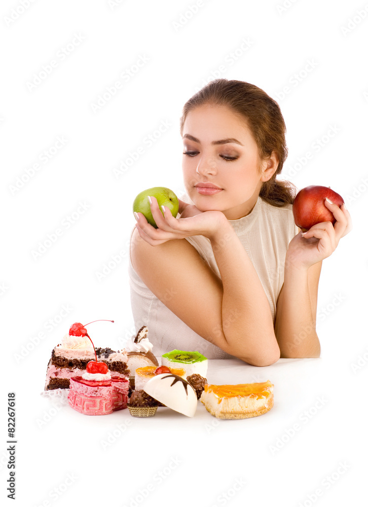 Young beautiful women with apples looking at cookies Young beautiful women with apples looking at cookies