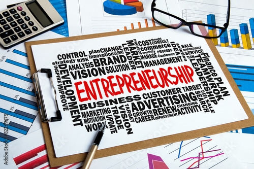 Entrepreneurship with related word cloud handwritten on clipboar photo