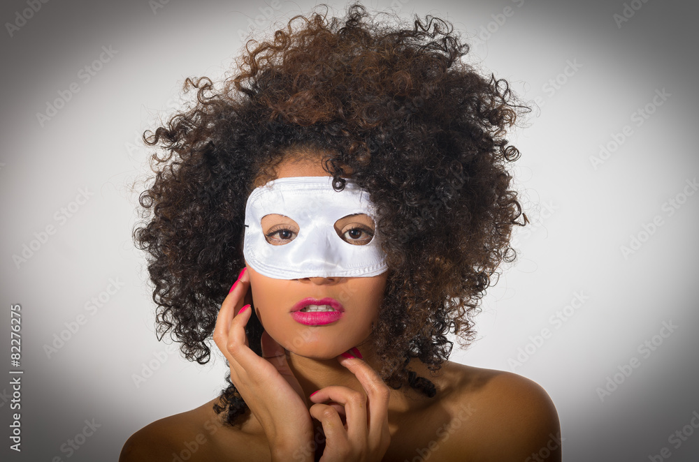 young woman with short curly dark hair wearing a mask young woman with short curly dark hair wearing a mask