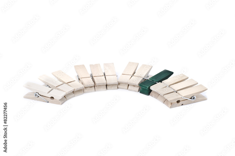 Fototapeta premium concept be different with focus on green clothes clip