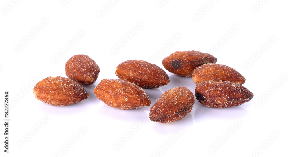 salted and roasted almonds on white background salted and roasted almonds on white background