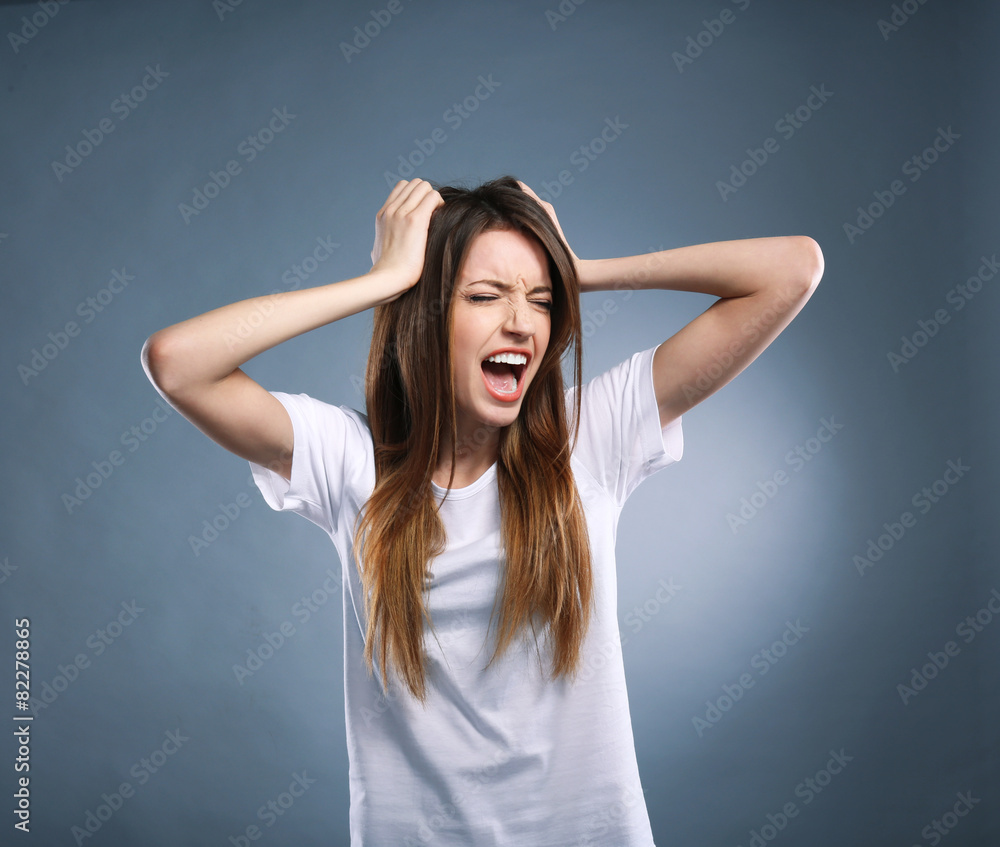 Portrait of young woman on grey background Portrait of young woman on grey background