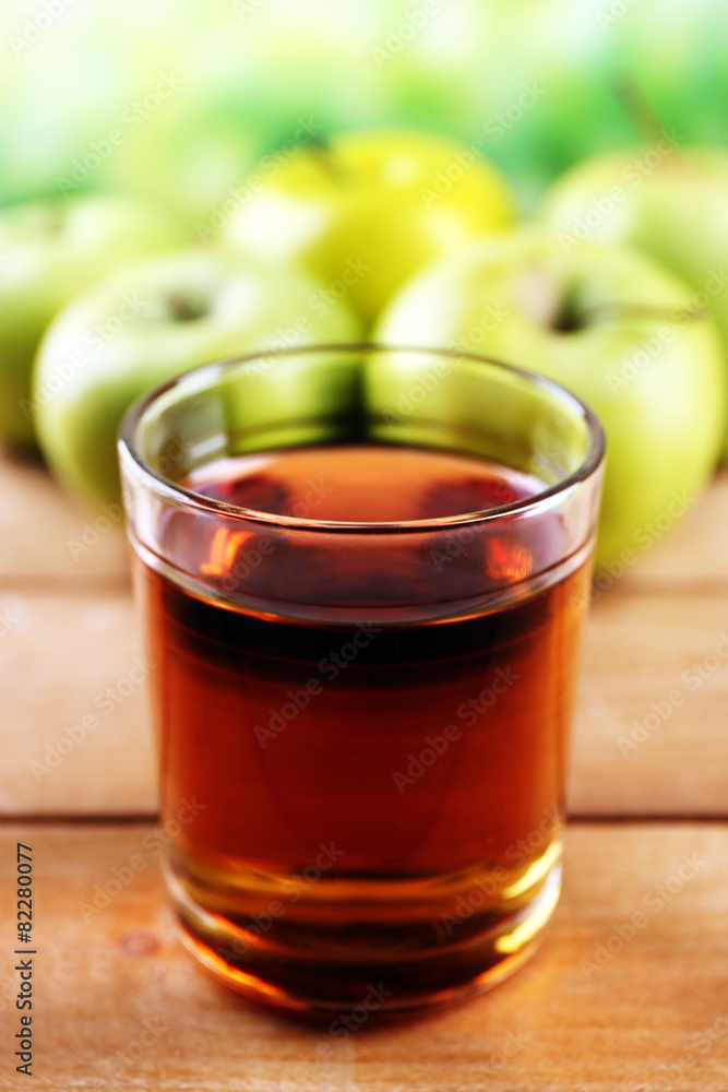 Glass of healthy fresh juice of apples on wooden background Glass of healthy fresh juice of apples on wooden background