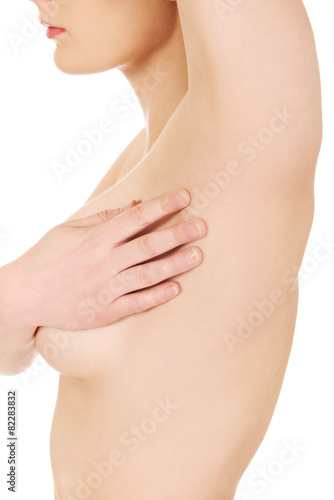 Young woman touching her armpit.