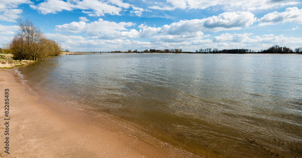 Sandy banks of a river on a beautiful day in springtime