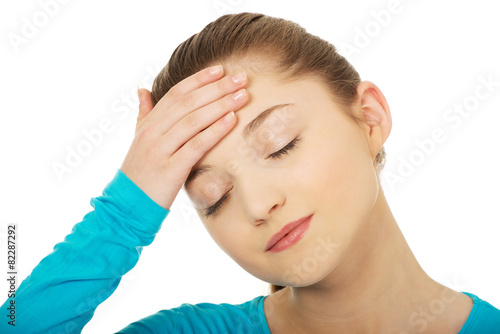 Teen woman with headache.