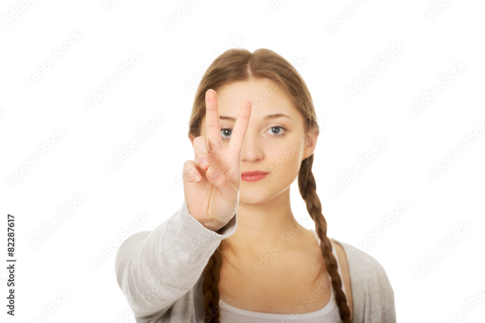 Happy teenager with victory gesture.