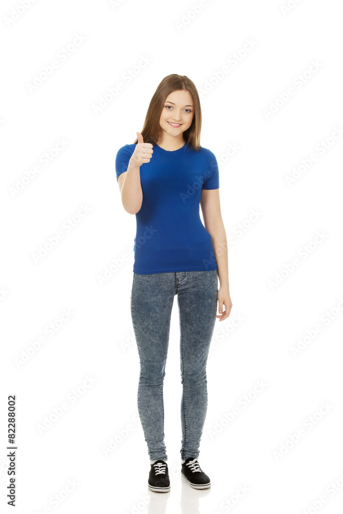 Happy female student showing thumbs up. Happy female student showing thumbs up.