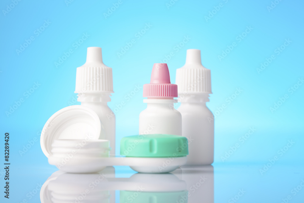 eye drops and contact lenses case on blue background eye drops and contact lenses case on blue background
