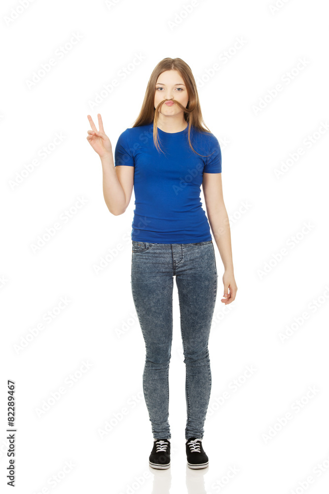 Teenager making moustache from hair. Teenager making moustache from hair.