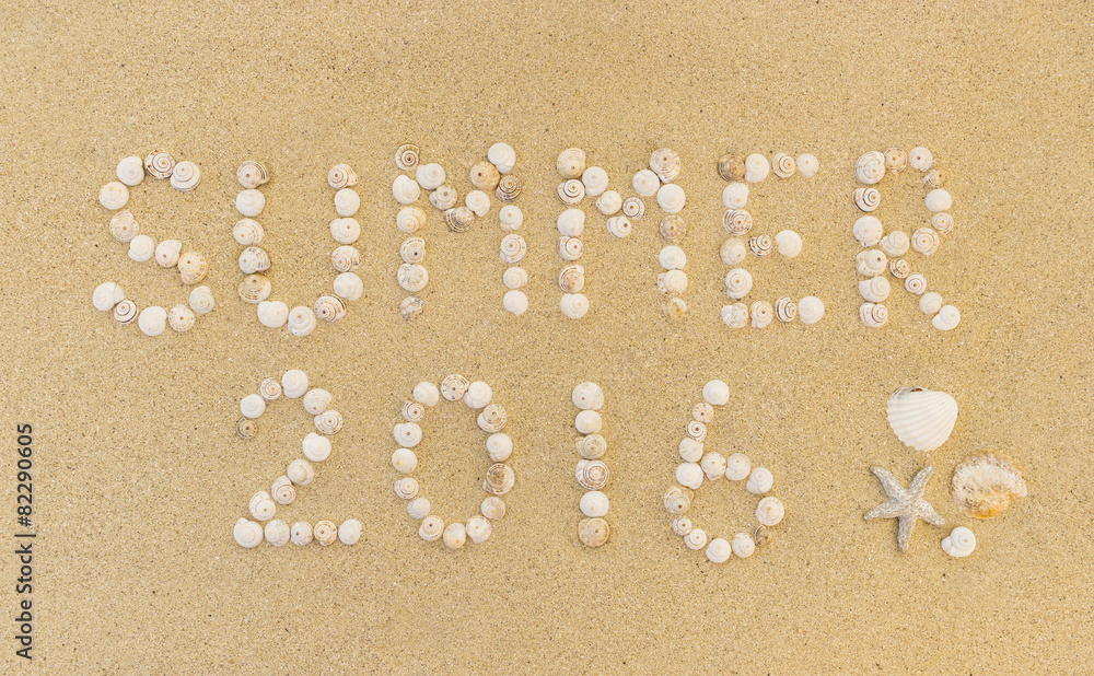 Word SUMMER 2016 written in sand