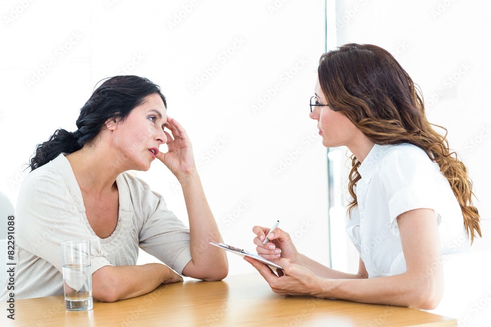 Depressed woman talking to her therapist