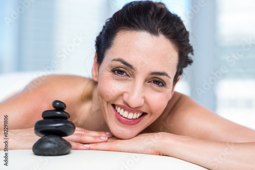 Smiling brunette relaxing on massage table