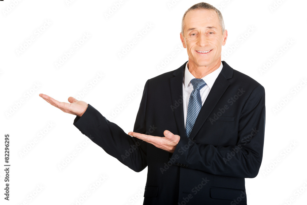 Portrait of businessman with welcome gesture Portrait of businessman with welcome gesture