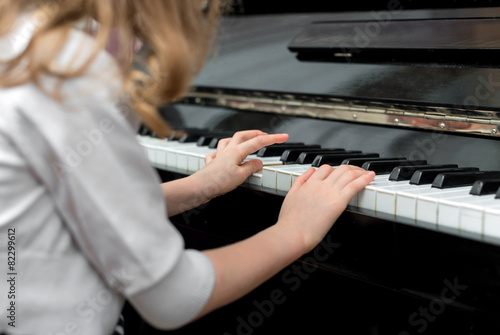 Child learns to play the piano.