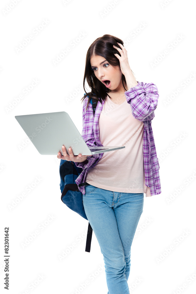 Surprised woman standing and looking on laptop screen Surprised woman standing and looking on laptop screen