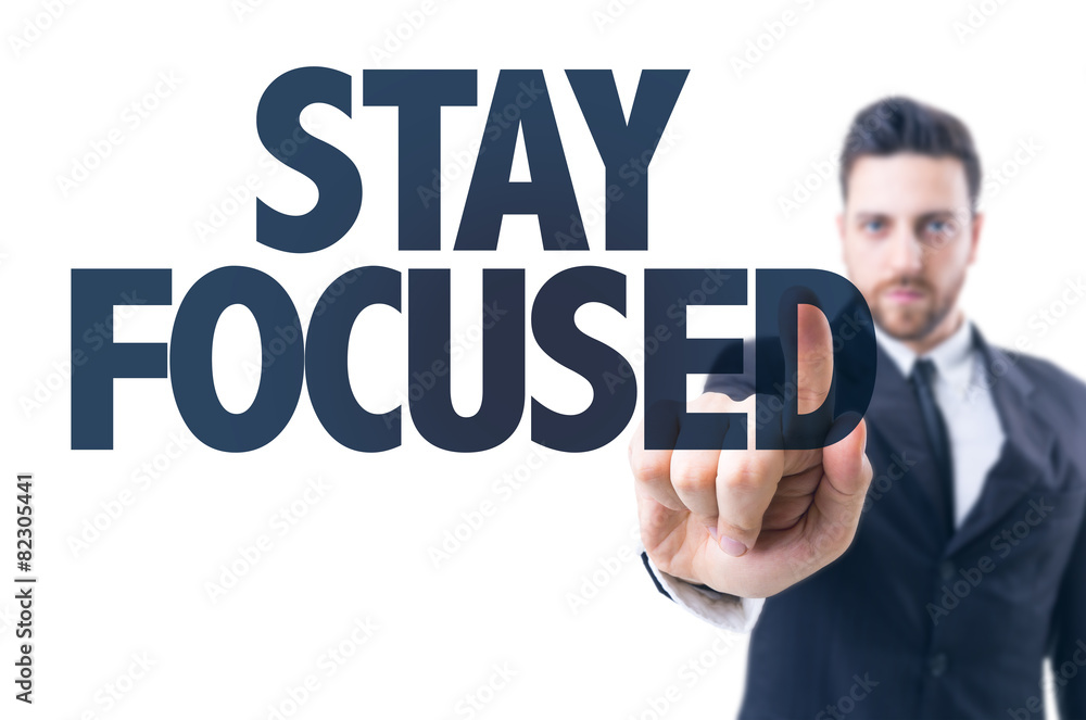 Business man pointing the text: Stay Focused Business man pointing the text: Stay Focused