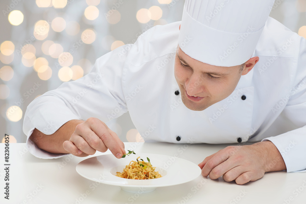 happy male chef cook decorating dish