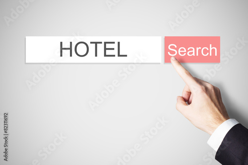 businessmans finger pressing search button hotel webbrowser photo