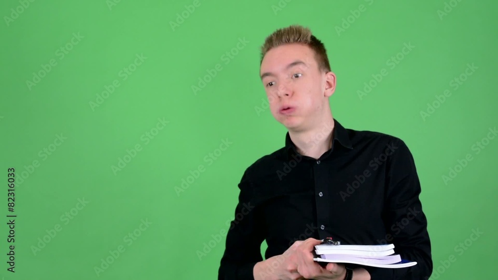 young handsome man holds textbooks tired - green screen - studio young handsome man holds textbooks tired - green screen - studio