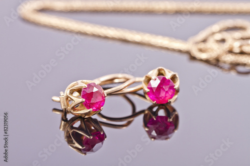 Small gold earrings with semi-precious stones ruby color