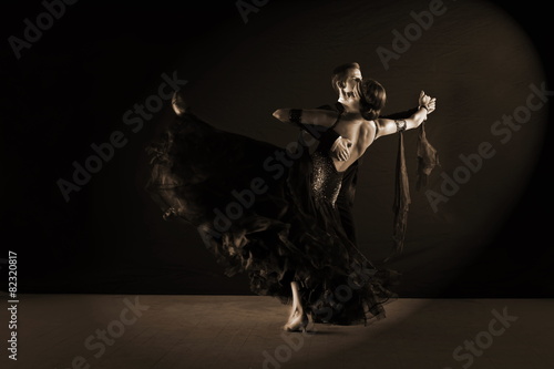 Dancers in ballroom at black background