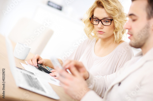 Unhappy couple with documents at home
