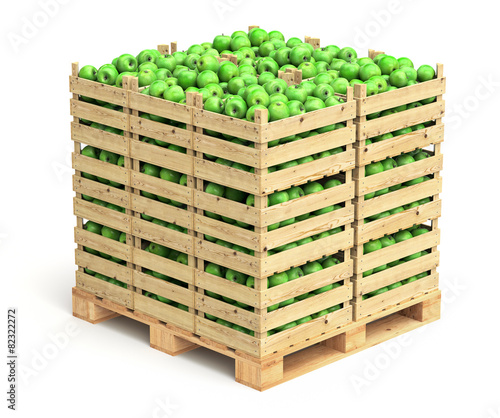 Green apples in wooden crates