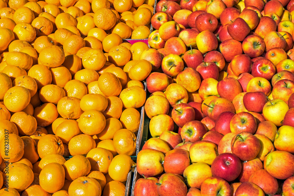 Clementines and apples for sale at a market
