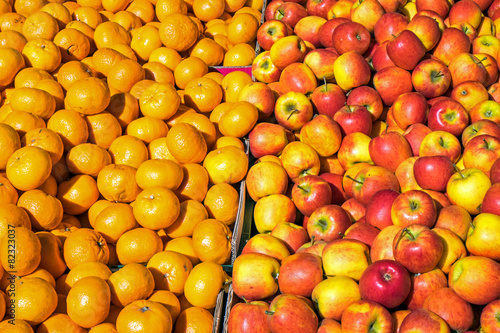 Clementines and apples for sale at a market