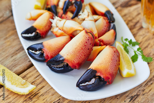 Boiled crab claws on a plate and beer