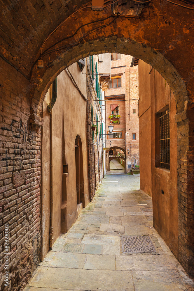 Fototapeta premium Hidden streets of the ancient city of Siena, Italy