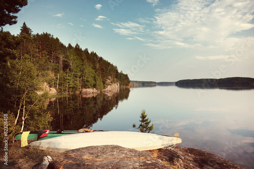 Kayaks on the lake shore with Instagram style filter